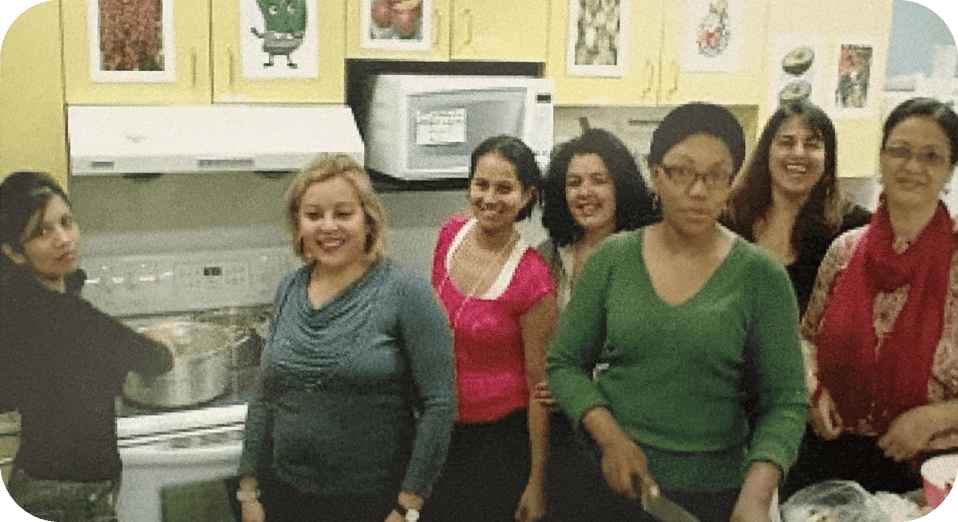 Peer Ambassadors leading a Spanish community kitchen program to support cultural connection and community well‑being